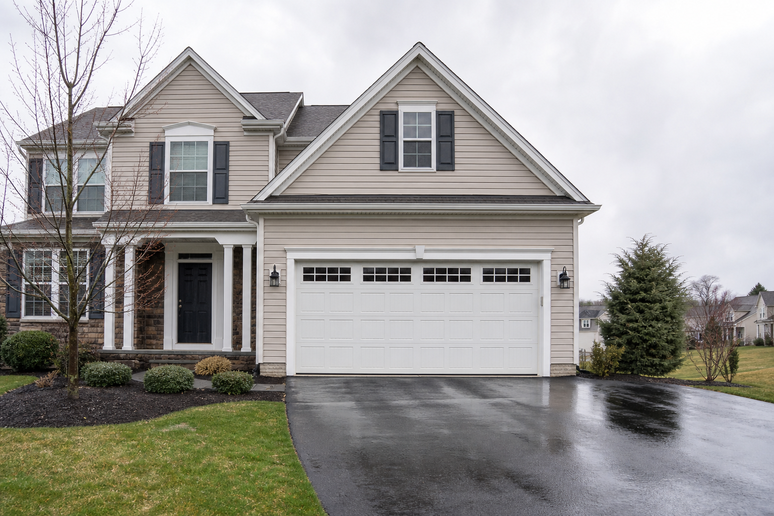 Suburban home in Bedminster with a closed garage door after rain